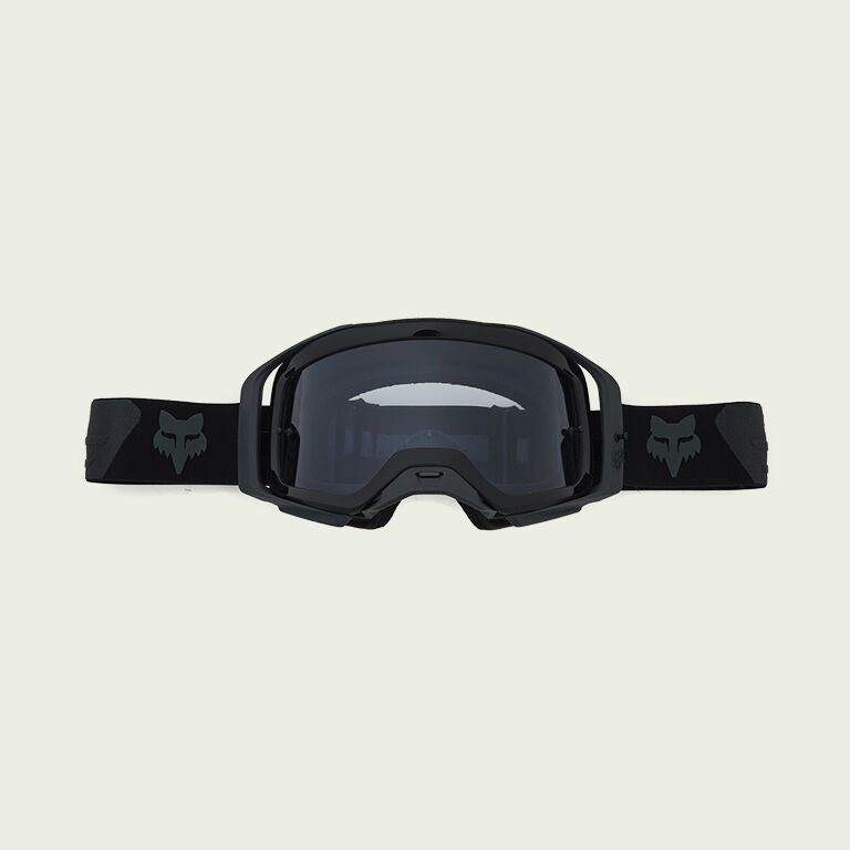 dark goggles on green background