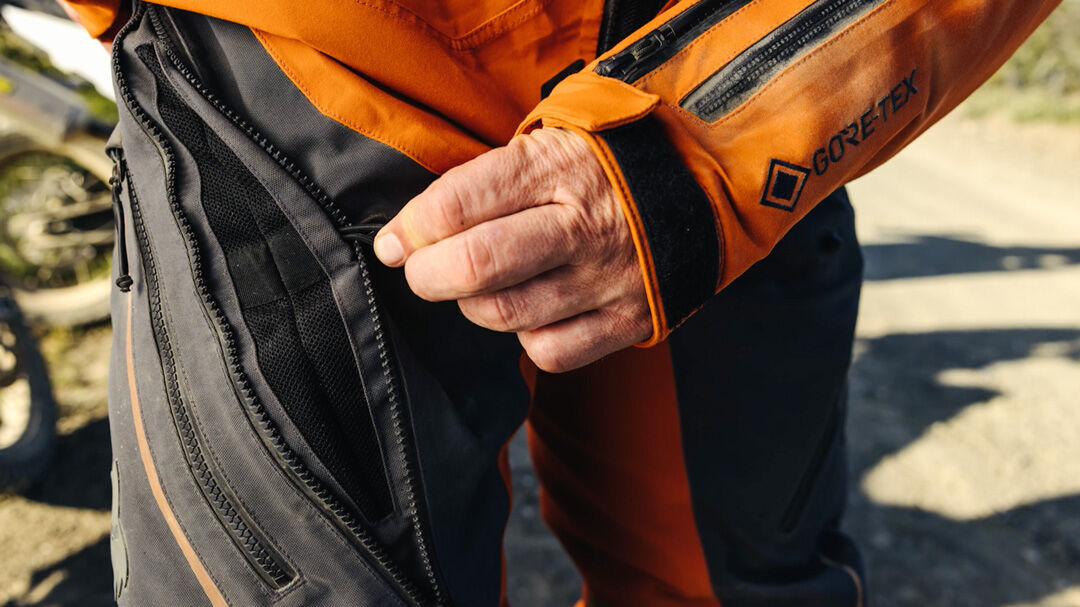 Man in a grey, orange ADV jacket.