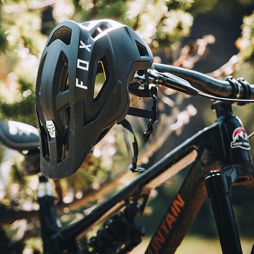 Speedframe helmet hanging on a mountain bike's handlebar.
